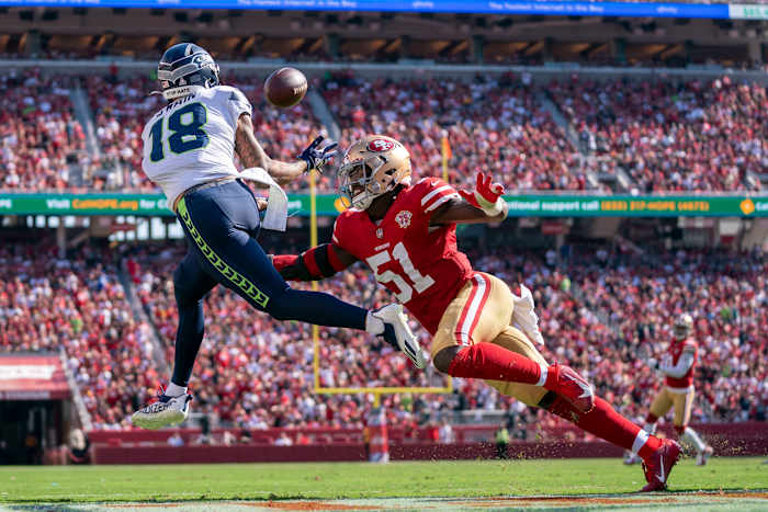 Seattle Seahawks wide receiver Freddie Swain (18) catches a touchdown pass against San Francisco 49ers linebacker Azeez Al-Shaair (51) during the third quarter at Levi's Stadium.